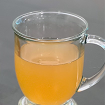 a clear mug filled with apple cider